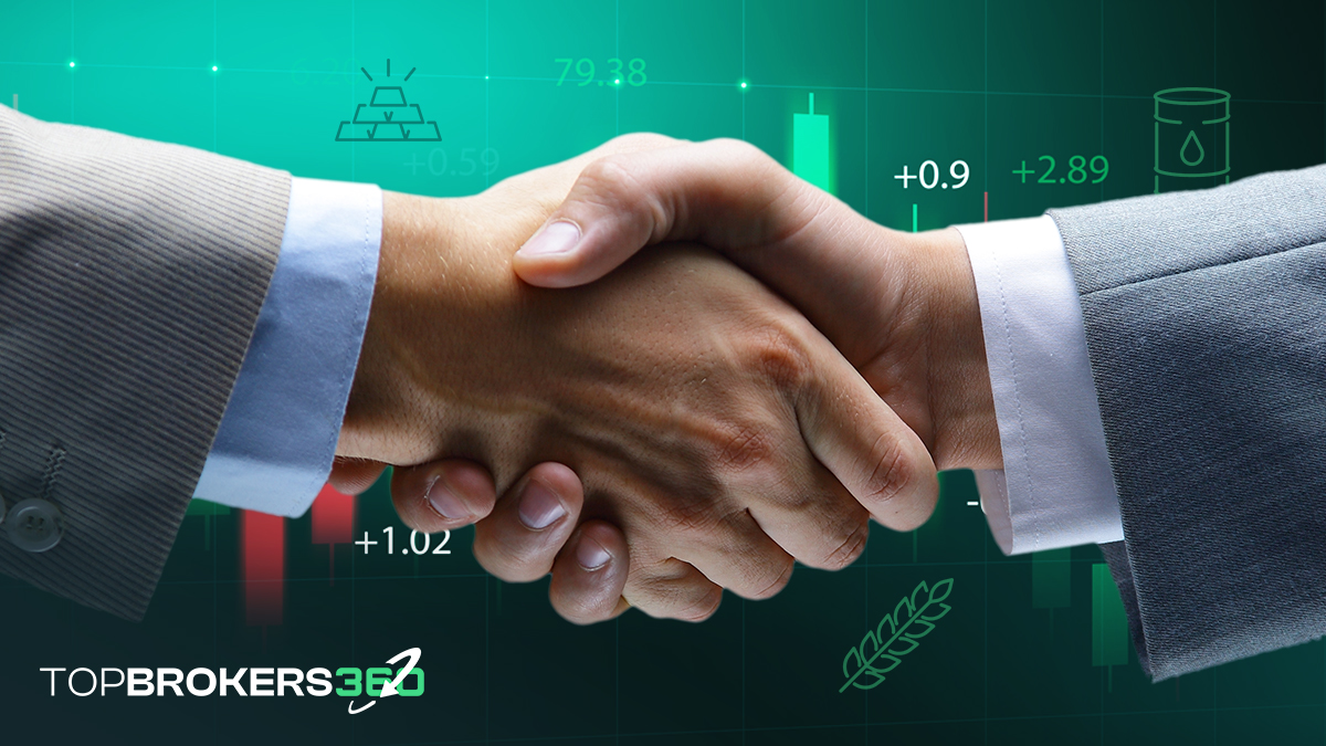 Ein Händedruck vor einem Hintergrund von Rohstoffcharts und -grafiken, der die Vereinbarungen und Transaktionen symbolisiert, die die Rohstoffhandelsbranche antreiben.
